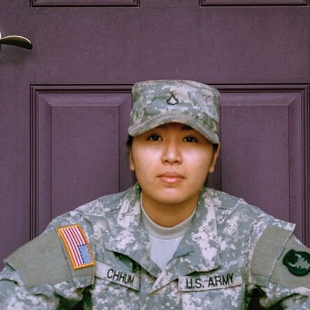 woman sitting in front of closed door